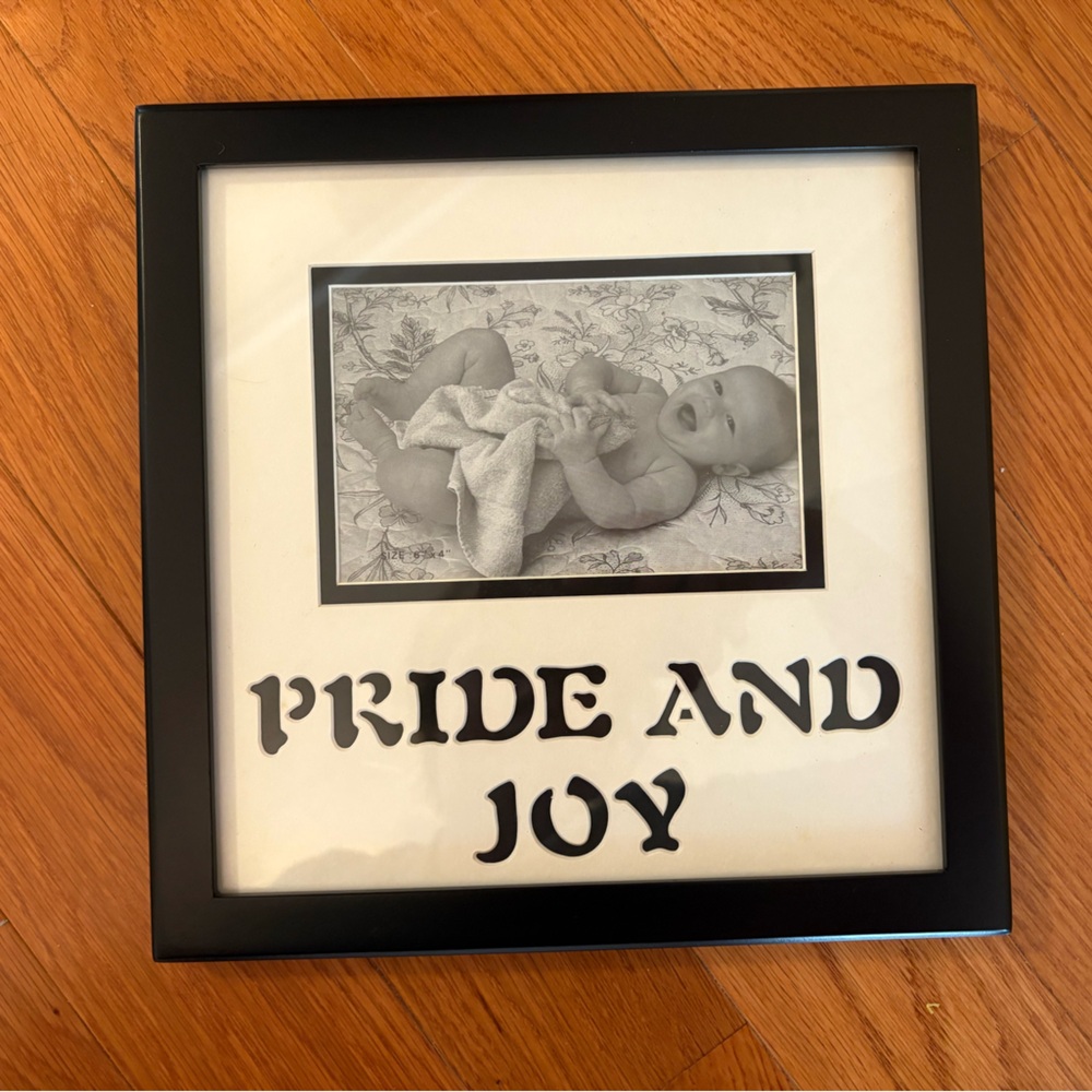 Black Picture Frame with 'Pride and Joy' Text
